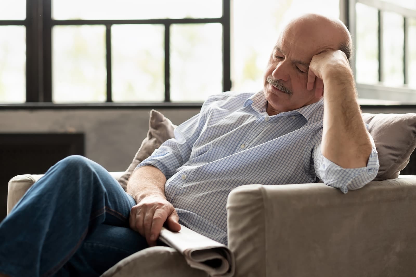 Man napping in chair needs sleep reset